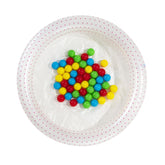 White bowl with colorful candies on a white background