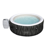 Inflatable hot tub with water and pump on a white background, featuring the Lay-Z-Spa brand.